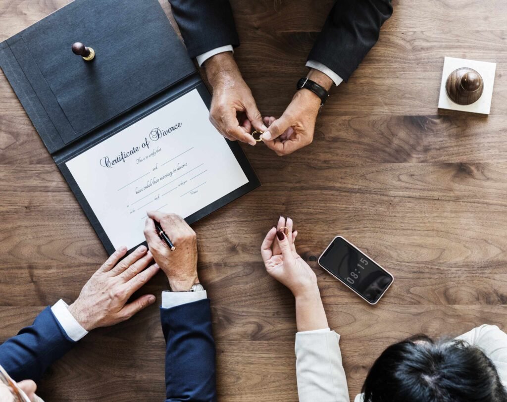 couple finalizing a divorce by signing a contract.